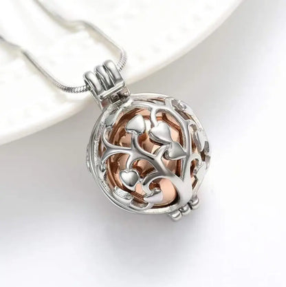 Tree of Life pet memorial urn necklace with a rose gold inner sphere.