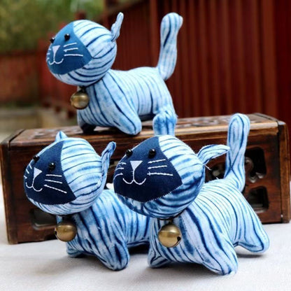 A group of three hand-dyed indigo plush cats, showing the unique and one-of-a-kind patterns on each memorial keepsake.