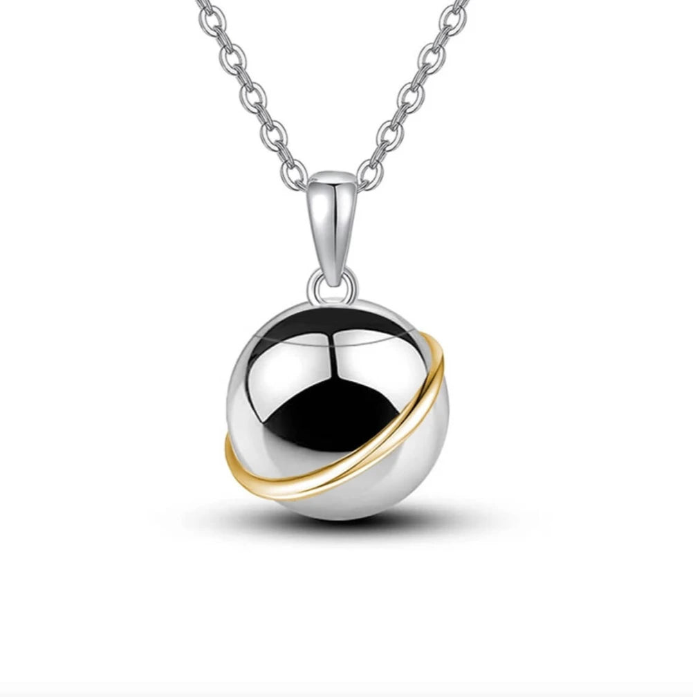 Front view of the polished unisex planet pet memorial necklace for ashes designed in minimalist silver and gold rings.