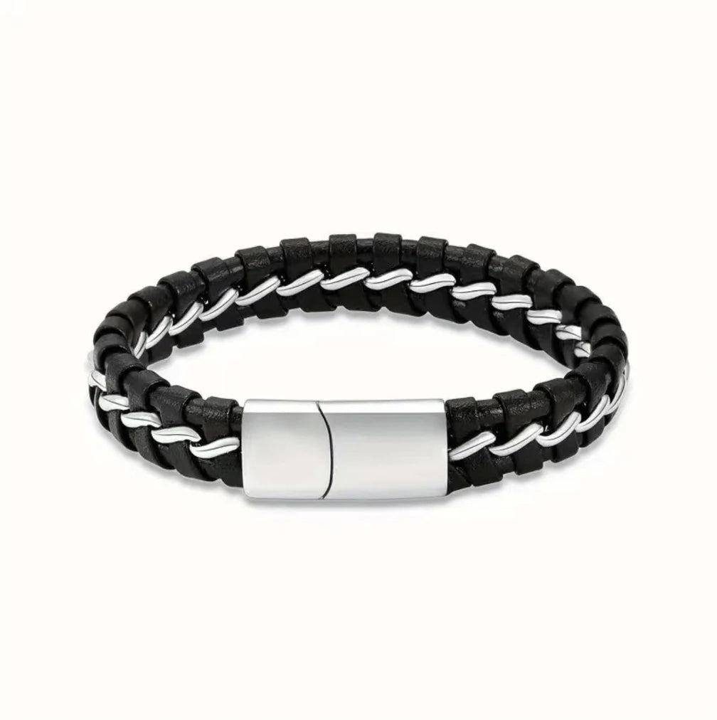 Close-up view of a premium black braided genuine leather pet memorial urn bracelet for ashes featuring a distinctly bold masculine white black stainless steel interlocking clasp.